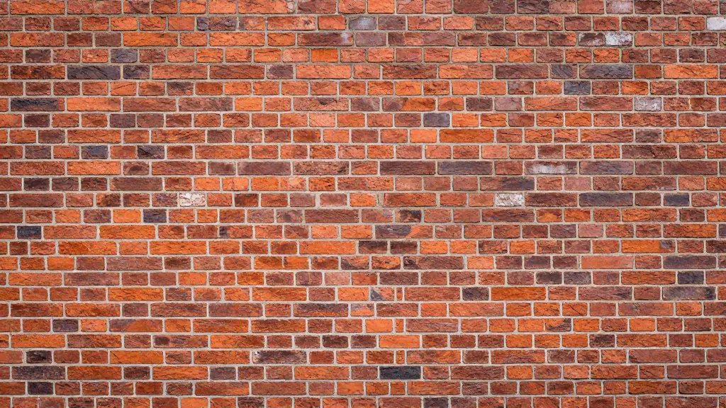 Wide view of a historic brick façade showing newly repointed joints