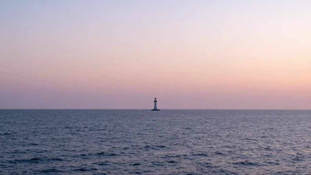 Expansive coastal coastline at sunset, soft pastel sky, single distant lighthouse silhouette