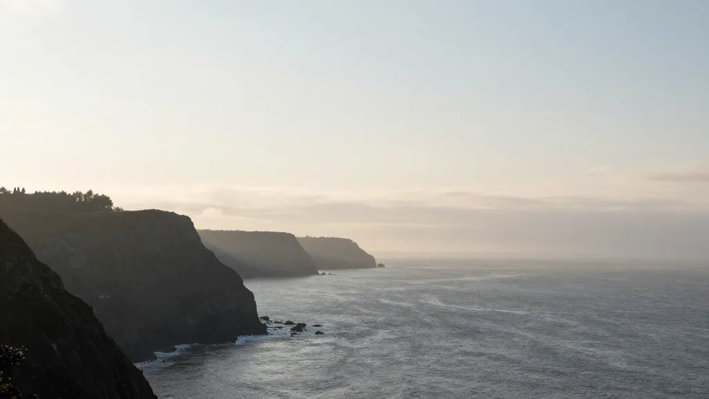 Distant coastal cliffs with misty horizon and soft light