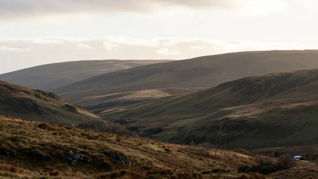 Expansive Scottish Highlands with rolling hills, subtle sunrise light
