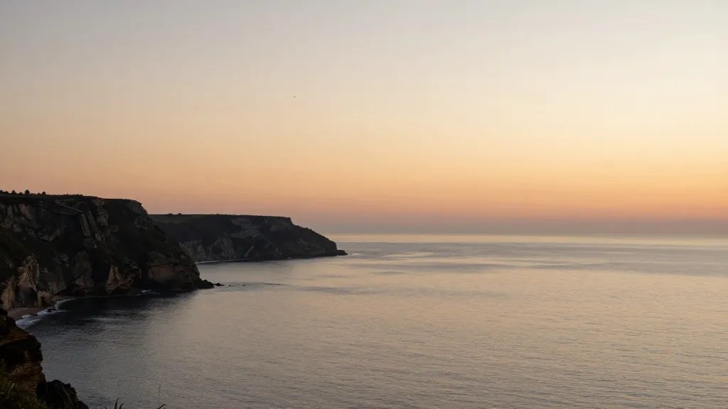 Distant view of a calm coastal cliff at sunset