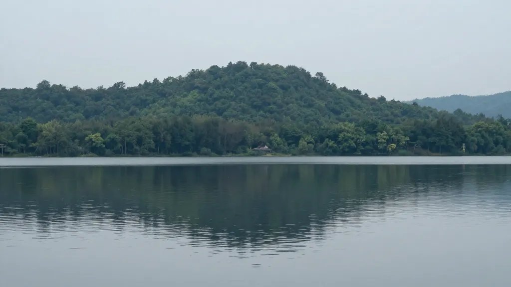 distant landscape of a calm lake reflecting a forested ridge