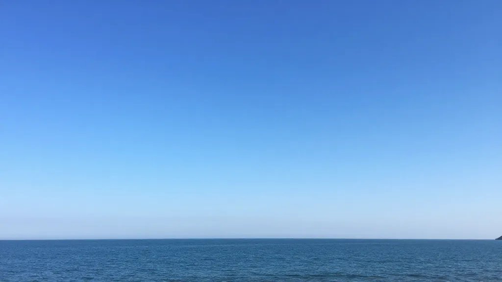 distant landscape of a pristine coastline under clear blue skies